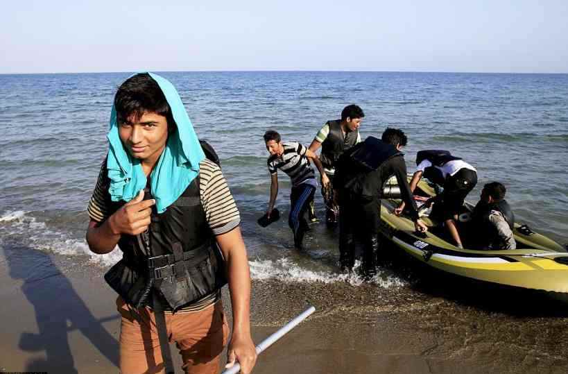 KOS2B326BBD00000578-3190377-New_arrivals_An_Afghan_migrant_smiles_as_he_reaches_the_sands_of-a-56_1439044784087