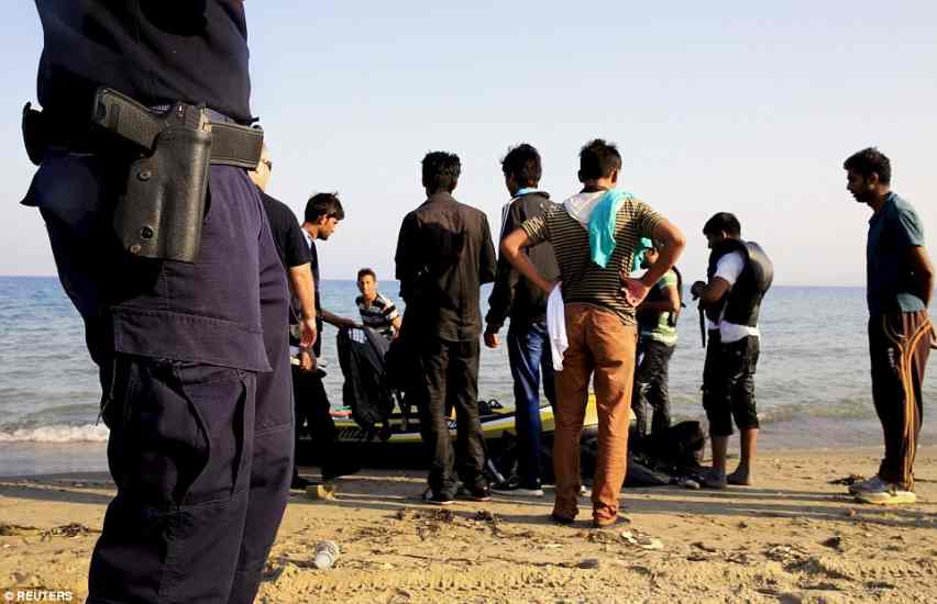 KOS2B326DC400000578-3190377-Stepping_in_Greek_coast_guard_officers_talk_to_the_new_migrants_-a-66_1439044784327