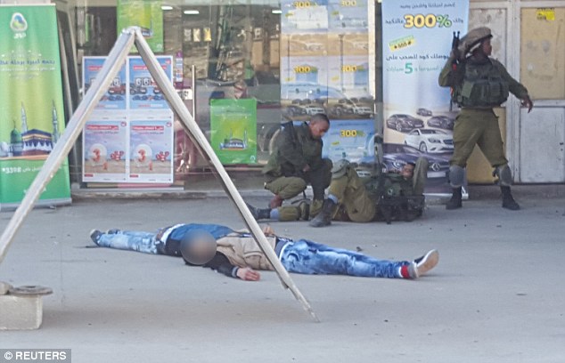 2FA2C6ED00000578-3375331-The_bodies_of_two_Palestinians_aged_17_and_23_who_the_Israeli_mi-m-13_1451235094279